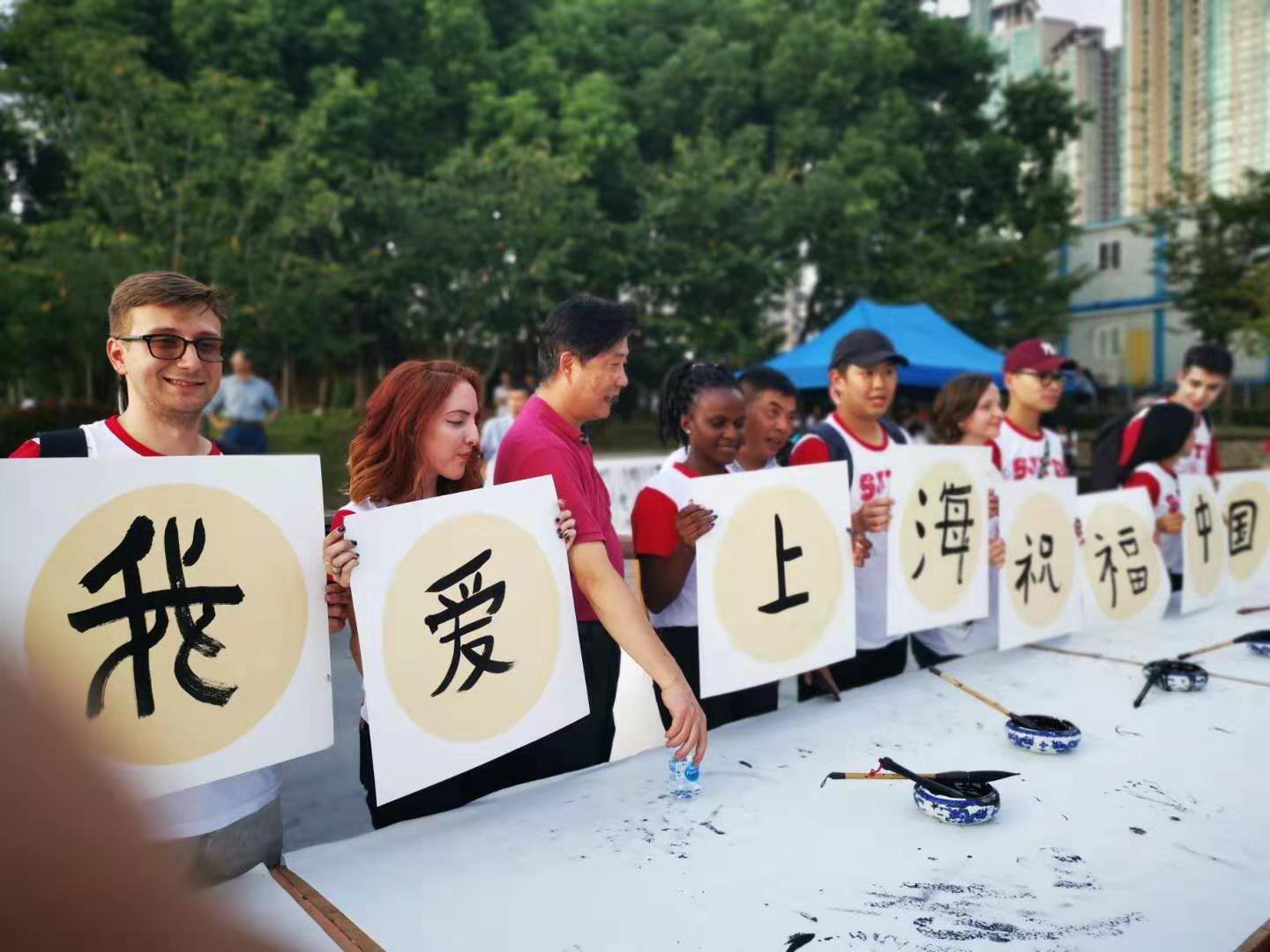 3) International students practice their calligraphy skills while instructors give them tips..jpeg